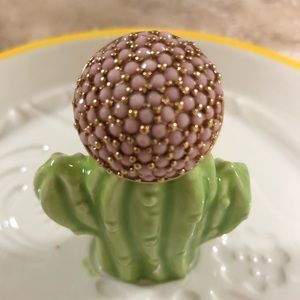 Pink bead and gold tone ring.